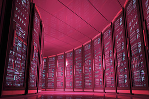 Row of server cabinets with computer and digital displays full of data and numbers, arranged in circular rows in a data center room, illuminated by red light at night. View from an aisle, with dim illumination. Simulation of supercomputer and cloud computing storage room. Low angle view, camera close to the floor. Digitally generated image.