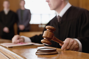 Judge holding gavel in courtroom