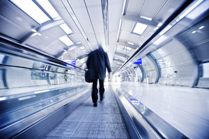 Business traveler on airport moving belt